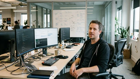 AI-generated image of an engineering manager at a desk with code on monitors.