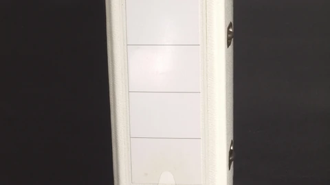 Several upright A5 ring binders with red and blue spines on a shelf. No people appear.
