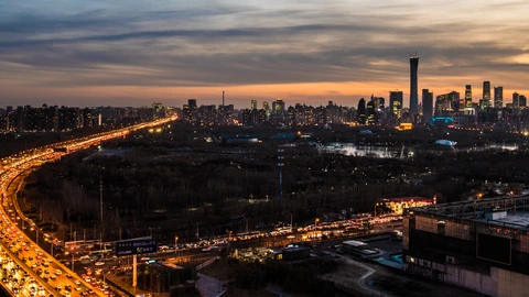 Cropped daylight view of Beijing high-rises under a hazy sky. No identifiable people appear.