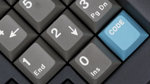 Macro close-up of black keyboard keys with white legends. No people appear.