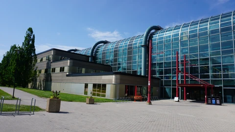 Glass and brick Davis Centre building on the University of Waterloo campus. No identifiable people appear.