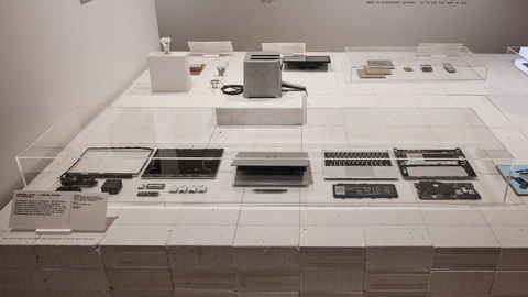 A Framework Laptop open on a pedestal in a museum gallery. No people appear.