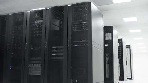 An empty server room with racks and blue accent lighting. No people appear.