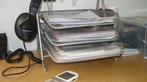 Two stacked metal inbox trays on a desk. No people appear.