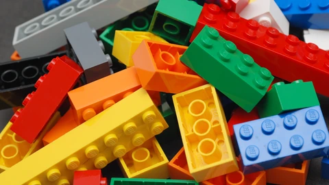 A heap of brightly colored LEGO bricks of mixed sizes. No people appear.