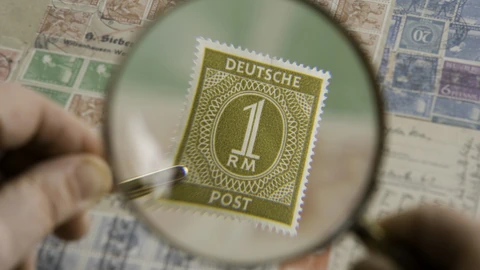 A handheld magnifying glass resting on a surface. No people appear.