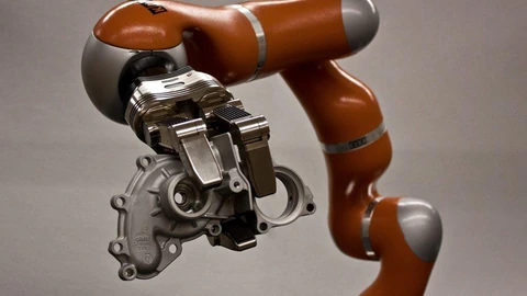 A laboratory dexterous manipulation testbed with robotic hands and fixtures on a table. No people appear.