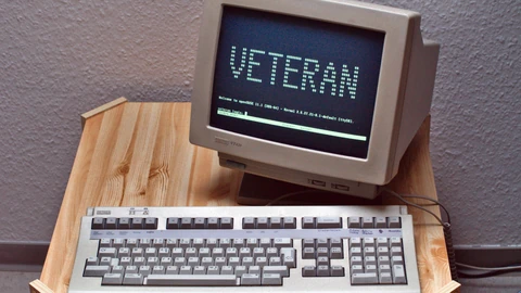 A DEC VT420 text terminal with a German keyboard on a desk. No people appear.