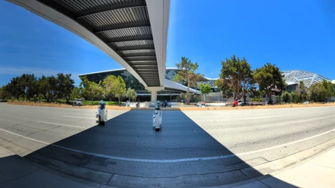 Multi-lane San Tomas Expressway beside NVIDIA campus buildings under a clear sky. No identifiable people appear.