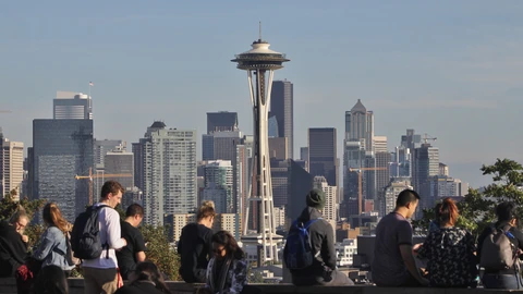 Seattle skyline with the Space Needle seen from Kerry Park under a pale sky. No identifiable people appear.