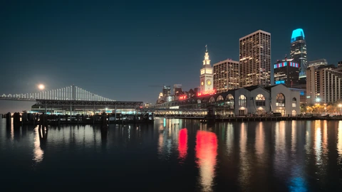 San Francisco Ferry Building clock tower seen from Pier 1 under a clear sky. No identifiable people appear.