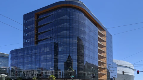 Glass office building at Third and 16th Streets in San Francisco’s Mission Bay, with Uber lettering on the facade and the Chase Center visible at right. No identifiable people appear.