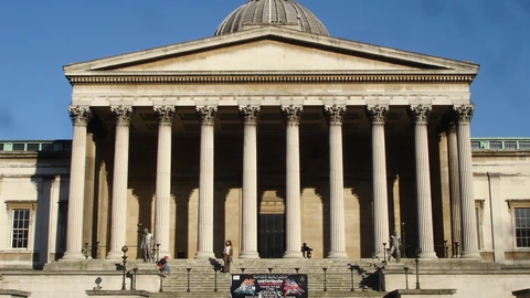 Daytime view of the UCL Portico Building colonnade and dome under a blue sky. No identifiable people appear in the frame.