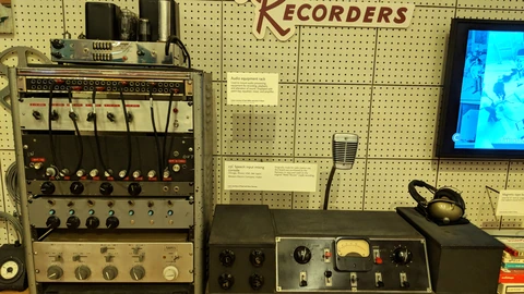 Vintage Western Electric mixing console and audio rack in a museum display. No people appear.