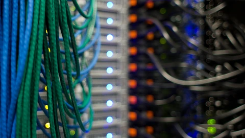 Close view of network cabling and ports on a server rack. No people appear.