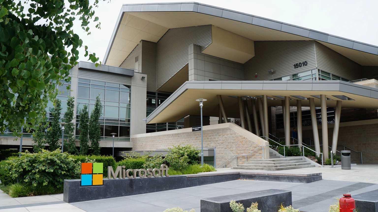 The Microsoft sign and entrance of Building 92 on the Redmond campus, with a peaked canopy and steps.