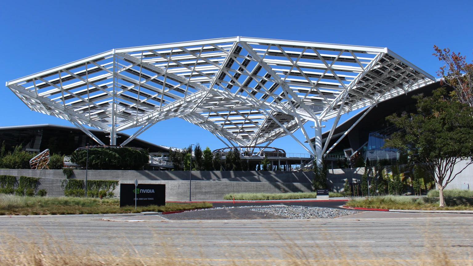 The NVIDIA headquarters entrance in Santa Clara, with a white canopy and an NVIDIA sign beside the driveway.