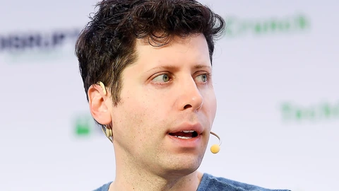 OpenAI CEO Sam Altman speaking at a microphone on the TechCrunch Disrupt San Francisco 2019 stage.