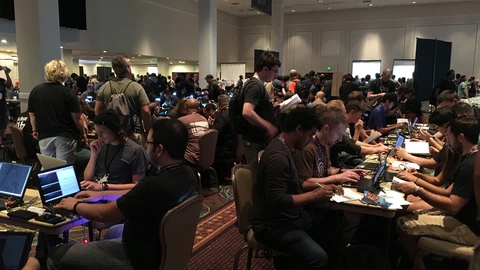 Rows of laptops and monitors on contest tables at the DEF CON 24 hacking conference.