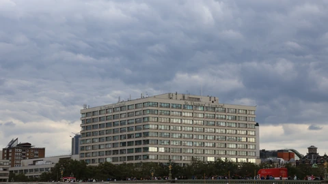 The riverside buildings of St Thomas' Hospital in London seen across the Thames on a sunny day.
