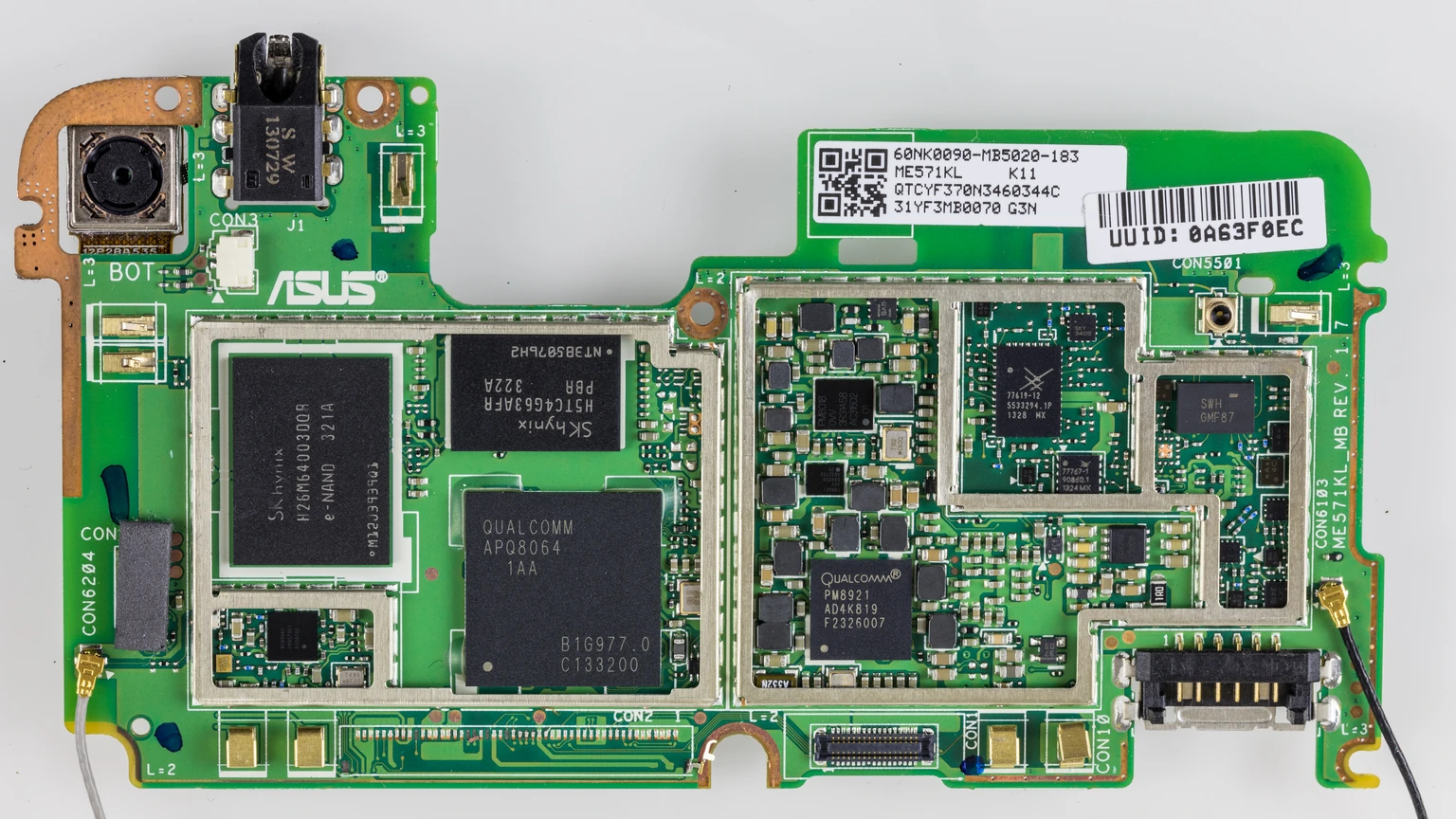 Green Nexus 7 2013 mainboard on a white background, with a Qualcomm APQ8064 SoC, SK hynix memory and ASUS markings inside a white outline.