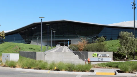 A glass NVIDIA headquarters entrance with a triangular roof, a flight of steps, and a sign reading nvidia 27888.