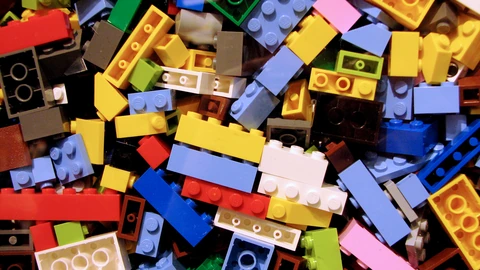 A dense pile of multicolored LEGO bricks filling the frame. No people appear.