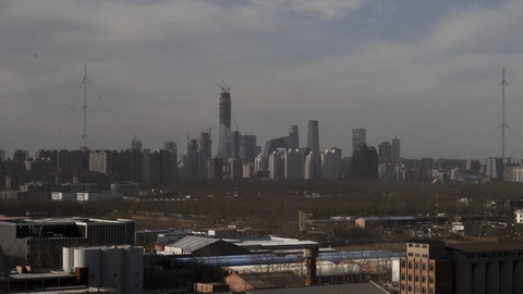 Beijing Chaoyang District skyline from the northeast with clustered glass towers. No identifiable people appear.
