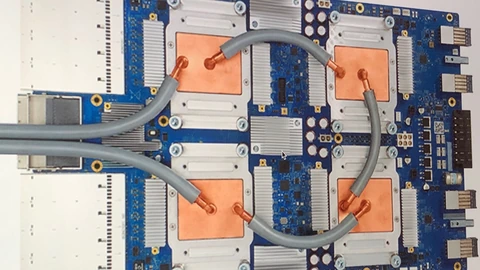 A Google Tensor Processing Unit 3.0 accelerator board on a dark surface. No people appear.