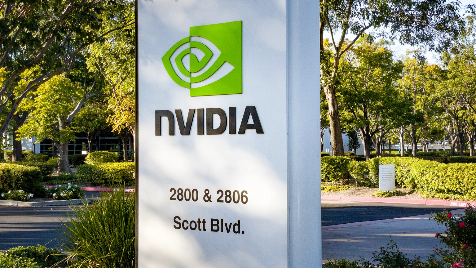 NVIDIA campus sign with landscaping and office buildings behind it. No identifiable people appear.