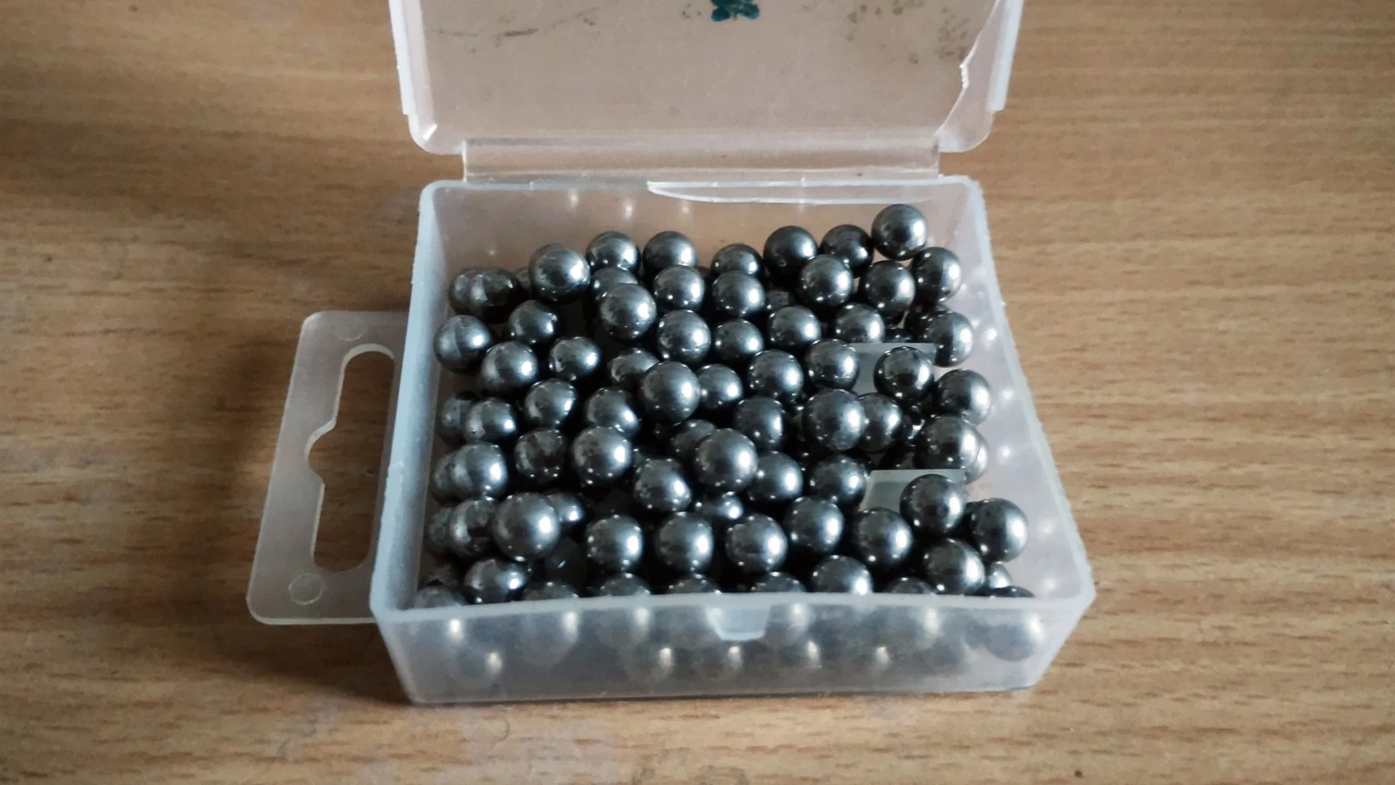 A close pile of shiny steel ball bearings filling the frame. No people appear.
