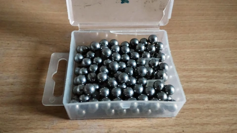 A close pile of shiny steel ball bearings filling the frame. No people appear.