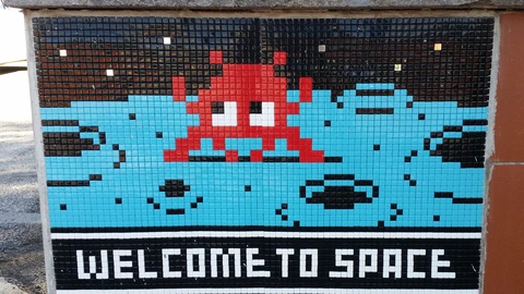 A mosaic reading 'Welcome to Space' at the entrance of ESA's ESRIN Centre for Earth Observation in Frascati, Italy. No people appear.