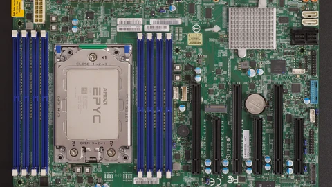 A green server motherboard with a large silver AMD EPYC processor in its socket, flanked by rows of blue memory slots.