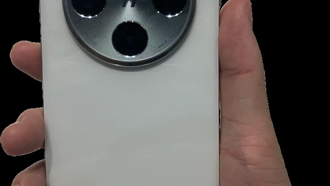 White OPPO Find X8 Pro smartphone lying face-down, showing its camera island and cloudy back finish on a pale surface.