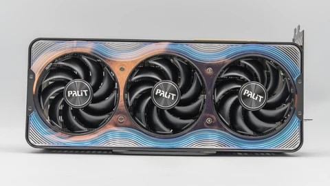 A Palit GeForce RTX 5090 Gamerock graphics card photographed head-on, showing three black fans in an iridescent blue and copper shroud.