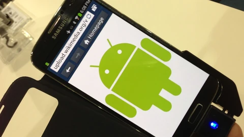 A black Samsung smartphone in a flip case, held at an angle, its mobile browser showing the green Android robot mascot on a white page.
