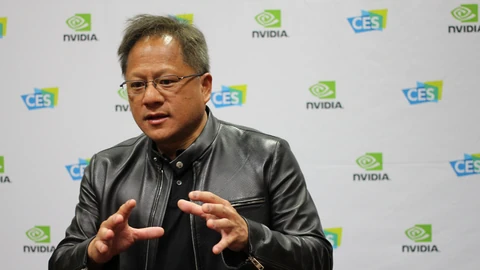 NVIDIA CEO Jensen Huang in a black leather jacket, gesturing with both hands in front of a backdrop of NVIDIA and CES logos.