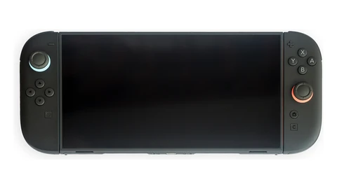 A dark Nintendo Switch 2 handheld console centered on a white background, screen off, Joy-Con controls visible.