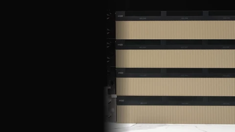 Four NVIDIA H100 graphics cards stacked on top of each other, with gold ribbed heatsinks and black NVLink bridges, on a white marble surface fading into a black background.
