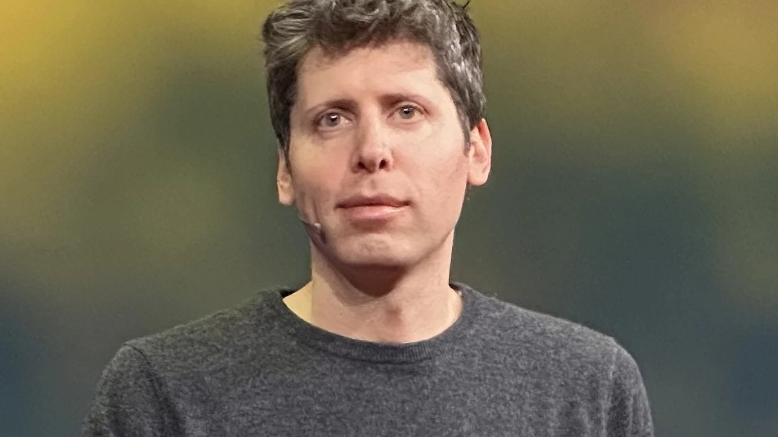 Sam Altman speaking onstage at TED.