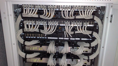 Managed Ethernet switches and network patch cables in a rack.