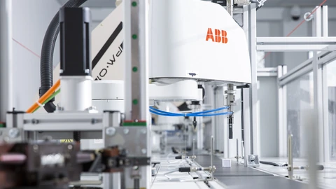 An ABB industrial robotic arm in a manufacturing laboratory.