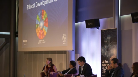 An AI ethics panel seated beneath a presentation screen.