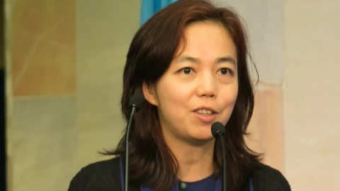 Fei-Fei Li speaking at AI for Good in 2017. Contextual photograph.