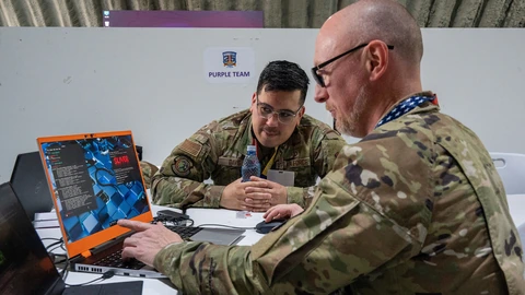 Maryland Air National Guard cyber operators Nathanael Lock and Anthony Davis conduct purple team operations with Romanian counterparts in 2025.