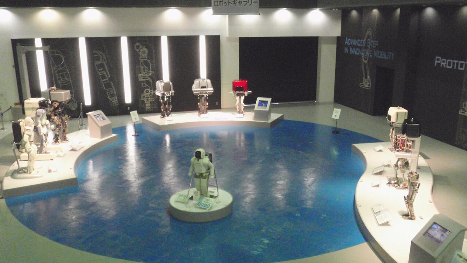 ASIMO and experimental bipedal robots displayed at Honda’s Fan Fun Lab.