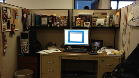 A programmer’s desk with computer displays and equipment.