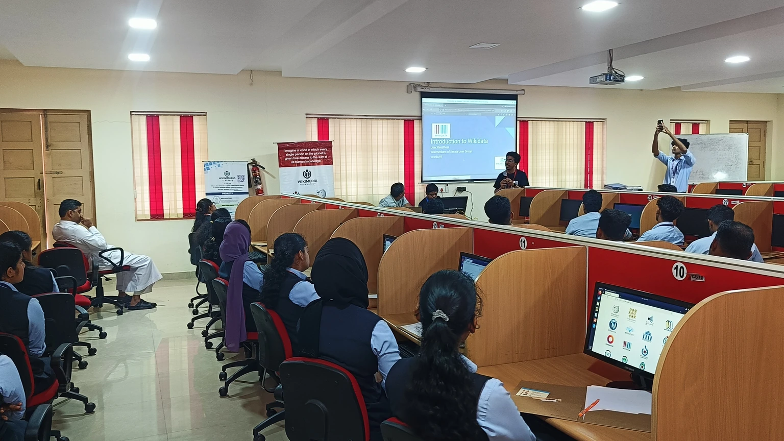 Students and instructors at a Wikimedia technical workshop in a computer classroom.