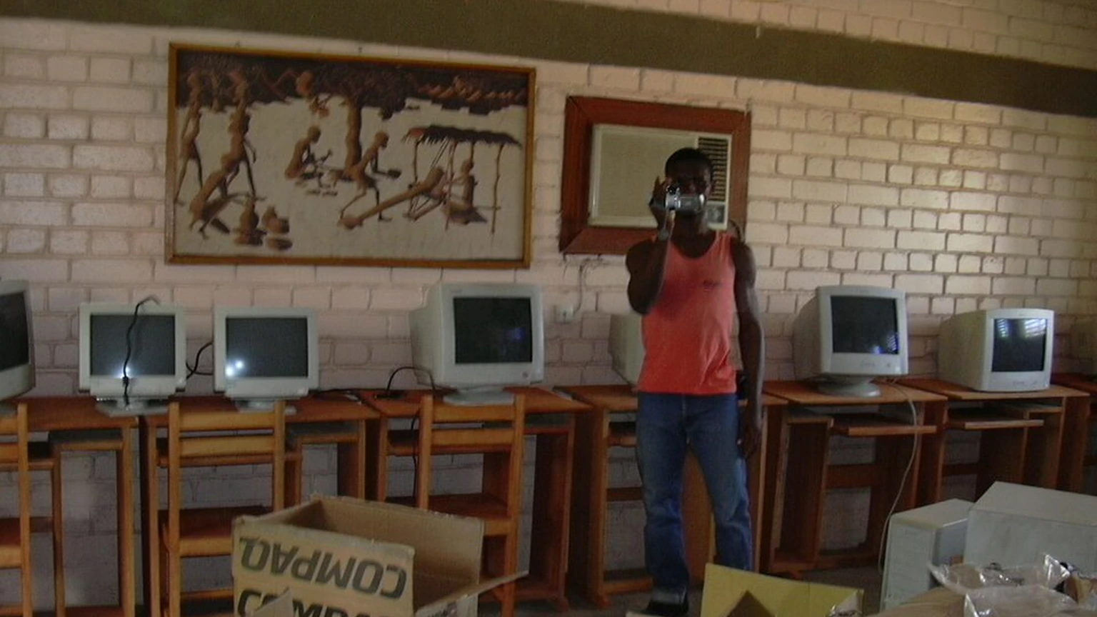 People unpacking second-hand computers at CIJEF in Ouagadougou, Burkina Faso.